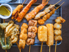 Table filled with skewered fried kushikatsu photo by Frozen Bayberry Shutterstock