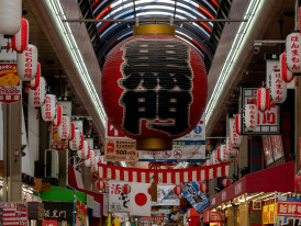 Covered arcade signage with hanging lanterns. Photo by 5010 on Unsplash