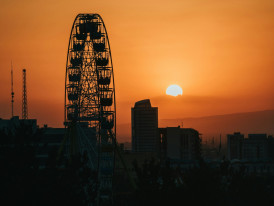 Ferris wheel against orange sunset photo by Photo by Mohammad Amirahmadi on Unsplash   