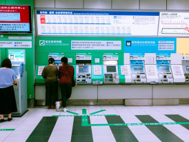 A guide explaining how to use a transit map or ticket machine to travelers at a train station or bus stop. Photo by Christian Chen on Unsplash