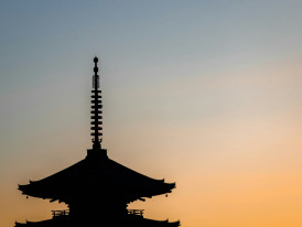 Sunset view over Kyoto's traditional rooftops with temple pagodas silhouetted against mountains. Image by Ricky from Unsplash