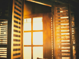 Early morning light filtering through traditional wooden lattice windows in Gion district. Photo by Mahdi Bafande on Unsplash