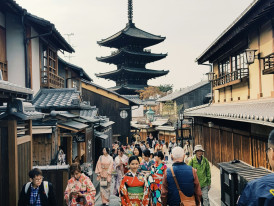 Traditional wooden buildings lining the historic Sannen-zaka street with visitors in kimono walking uphill Photo by Kevin Anggrek on Unsplash