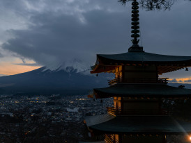 A sunset view over Kyoto with traditional architecture silhouetted against mountains Photo by Nicolas Lindsay on Unsplash
