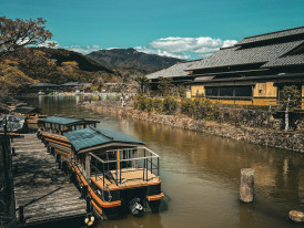 Historic buildings reflected in the calm waters of Uji River. Image by Apollo from Unsplash
