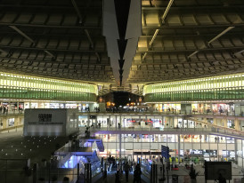 Modern glass architecture of Kyoto Station interior with travelers moving through Photo by Xavier Bentes on Unsplash