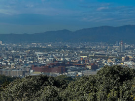 Panoramic view from Kyoto Station's observation deck showing city sprawl toward mountains Photo by Nelemson Guevarra on Unsplash