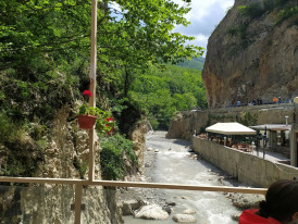Traditional platform dining over mountain stream with diners enjoying riverside meal Photo by Parvana Mahmudlu on Unsplash