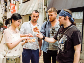 Guests and host enjoying street food.