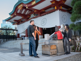 Local host explaining temple history to guest. 