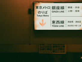 Multilingual signage at a major Osaka train station with tourists consulting maps Photo by ayumi kubo on Unsplash