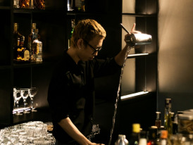 Bartender preparing cocktails in a small, atmospheric Osaka bar Photo by Nhat Anh Nguyen Chi on Unsplash