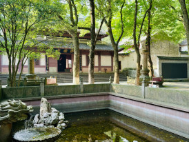 Quiet temple garden surrounded by city buildings Photo by Sean Wang on Unsplash