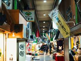 Local market vendors setting up their stalls in the early morning Photo by HYEWON HWANG on Unsplash