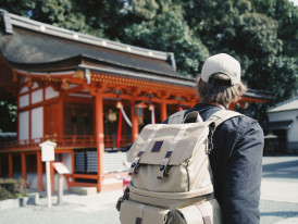 Visitor consulting a guidebook while standing in front of a temple Photo by bobby hendry on Unsplash
