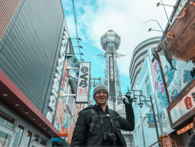 Tsutenkaku Tower rising above the narrow streets of Shinsekai district.