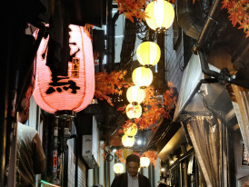 Traditional narrow alley with lanterns and historic restaurant facades.Photo by Perry Merrity II on Unsplash