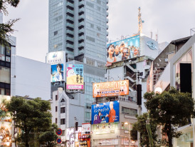 Colorful street art and vintage shop fronts in Amerika-mura district.