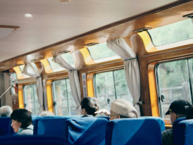 Interior of a Shinkansen train with early commuters Photo by Seele An on Unsplash