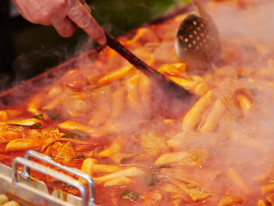 Close-up of street food vendor's hands working