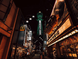 Kushikatsu, Shinsekai's signature dish, being prepared with the iconic Tsutenkaku Tower in the background Photo by Nguyen Hung Pexels