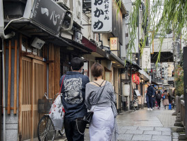 The atmospheric stone-paved alley of Hozenji Yokocho, a hidden gem steps away from Dotonbori