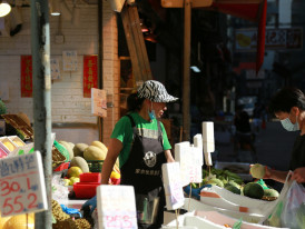 A local neighborhood market with vendors arranging fresh vegetables and chatting with customers Photo by Alison Pang on Unsplash