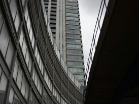 Looking up at modern Osaka skyscraper from street level perspective Photo by Randy Bailey on Unsplash