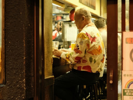 Elderly couple enjoying skewers at a corner eatery.  Photo by Perry Merrity II on Unsplash