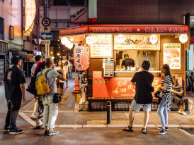 Late night street food vendor with satisfied customers