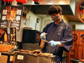Traditional izakaya owner preparing fresh dishes behind the counter for longtime customers Photo by Mircea Solomiea on Unsplash