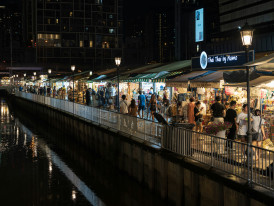 Authentic nightlife scene in business district with locals socializing after work Photo by Jin-Woo Lee on Unsplash
