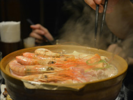 Traditional warm winter foods being enjoyed by locals in cozy restaurant setting Photo by Jerry Shen on Unsplash