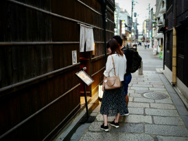 Local guide showing hidden gem to small group of interested visitors in authentic setting. Photo by Kazuo ota on Unsplash