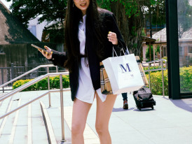 Smiling traveler holding shopping bags outside a boutique in Osaka Photo by Andrew Haimerl on Unsplash
