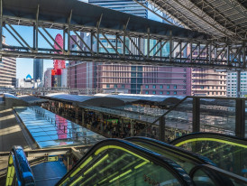 Early morning commuters at Osaka Station with dramatic lighting. Image by 