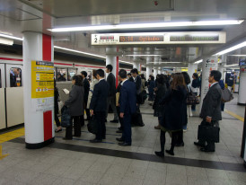 A crowded but orderly platform at Osaka Station during rush hour with commuters waiting for trains Photo by Marek Lumi on Unsplash