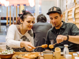 Final celebratory shot of diverse street foods and happy people enjoying them