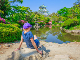 A peaceful morning scene at Osaka Castle grounds with soft light and minimal crowds.