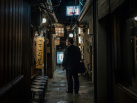  Guest stepping into a narrow, lantern-lit alleyway in Osaka's vintage district Photo by Guillaume Gouin on Unsplash