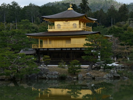 Kyoto temple complex with golden pavilion reflected in pond, guests admiring view. Photo by Ingeborg Korme on Unsplash