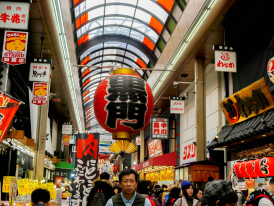 A bustling morning market with vendors selling fresh produce