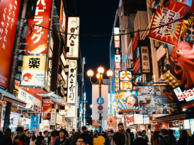 Narrow alley in Dotonbori with traditional lanterns and food vendors