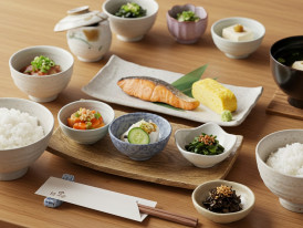 Traditional Japanese breakfast spread at a ryokan with multiple small dishes and rice.
