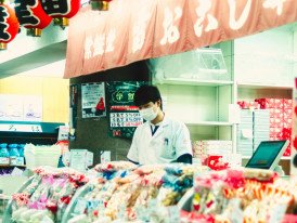 Packaged Japanese food souvenirs including Takoyaki mix, sauces, and local snacks arranged for display.Photo by Louis_ftn_on pexels