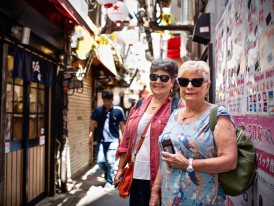 Guests posing for a photos while exploring narrow streets.