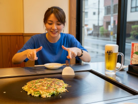 Mia cooking negiyaki at a self-cook grill