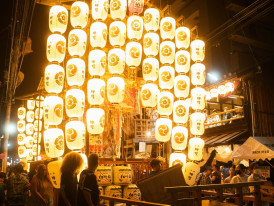 Paper lanterns illuminating neighborhood shrine grounds during evening summer festival. Photo by David Emrich on Unsplash