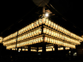 Traditional temple buildings illuminated at night with paper lanterns creating atmospheric lighting Photo by Adalee Penguin on Unsplash