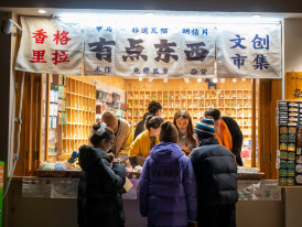 Traditional sweet shop vendor offering samples to interested customers Photo by leoon liang on Unsplash